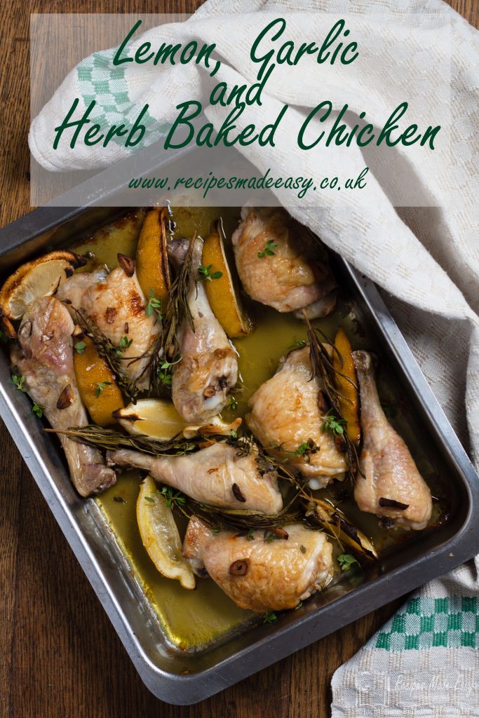 lemon, garlic and herb baked chicken in a roasting tine with oven cloth wrapped around tin