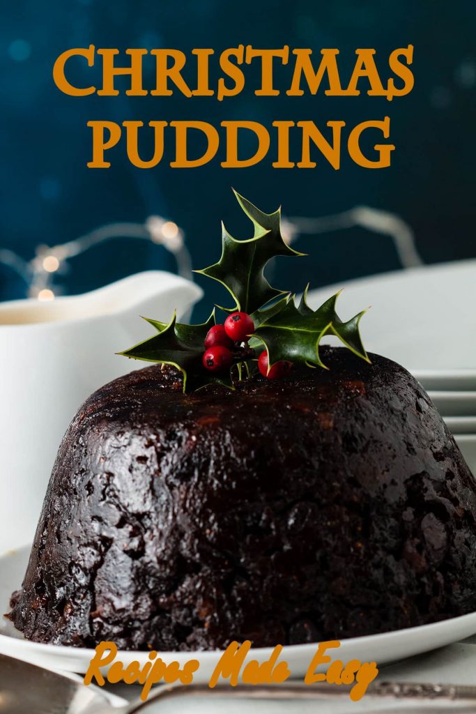 whole Christmas pudding decorated with holly and berries.