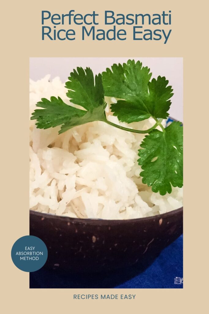 bowl of basmati rice in a coconut shell bowl. Garnished with coriander. Text over lay for Pinterest.
