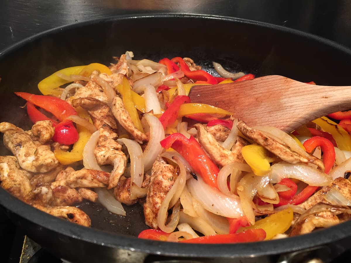 Chicken fajitas filling in pan.