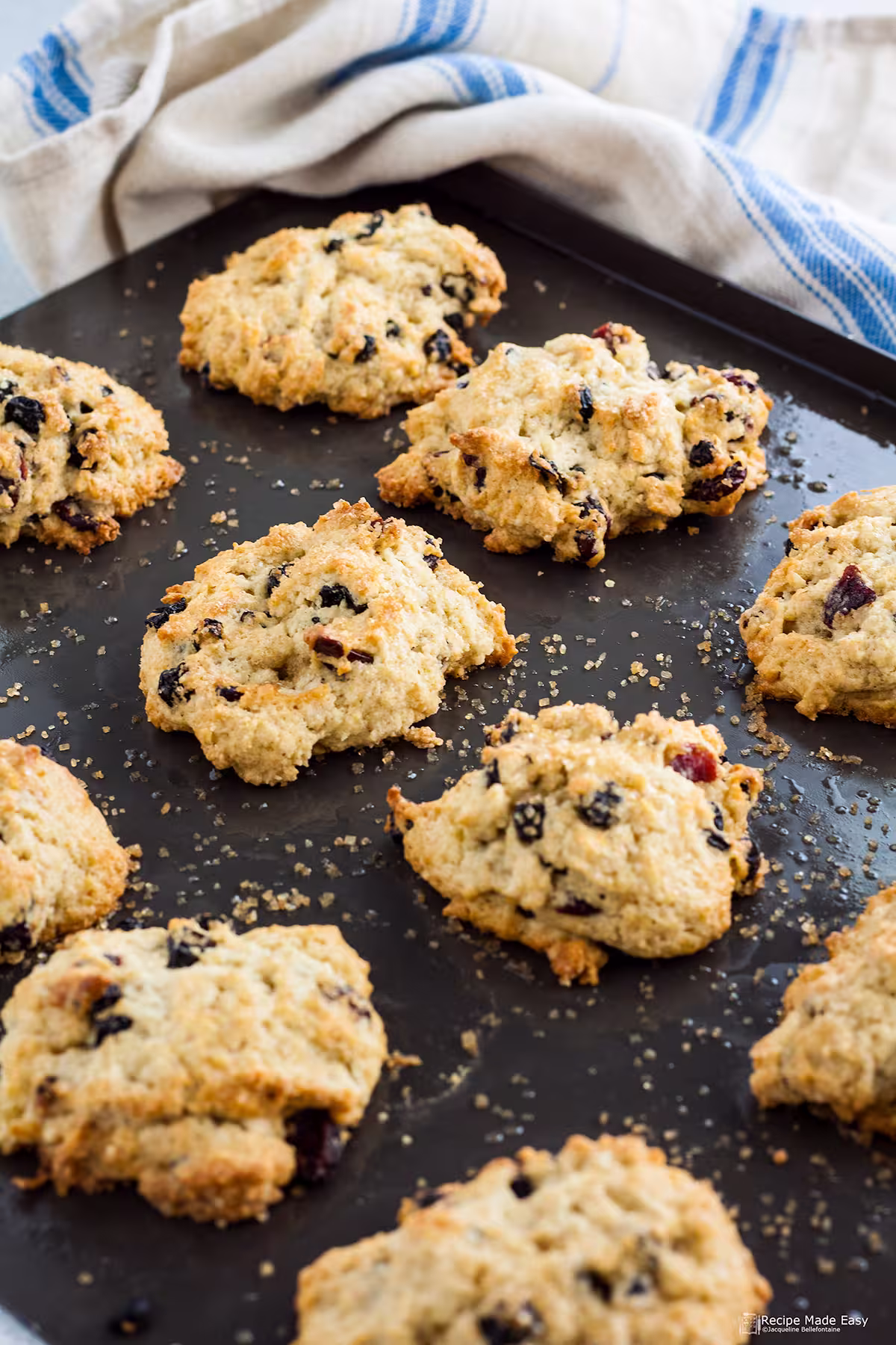 Rock cakes on a baking sheet with tea towel behind.