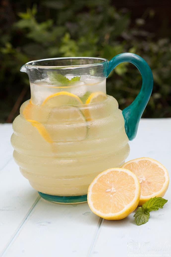 Lemon and limeade made easy in jug with lemons and mint next to jug.