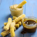churros with bowls of apple and salted caramel sauce.