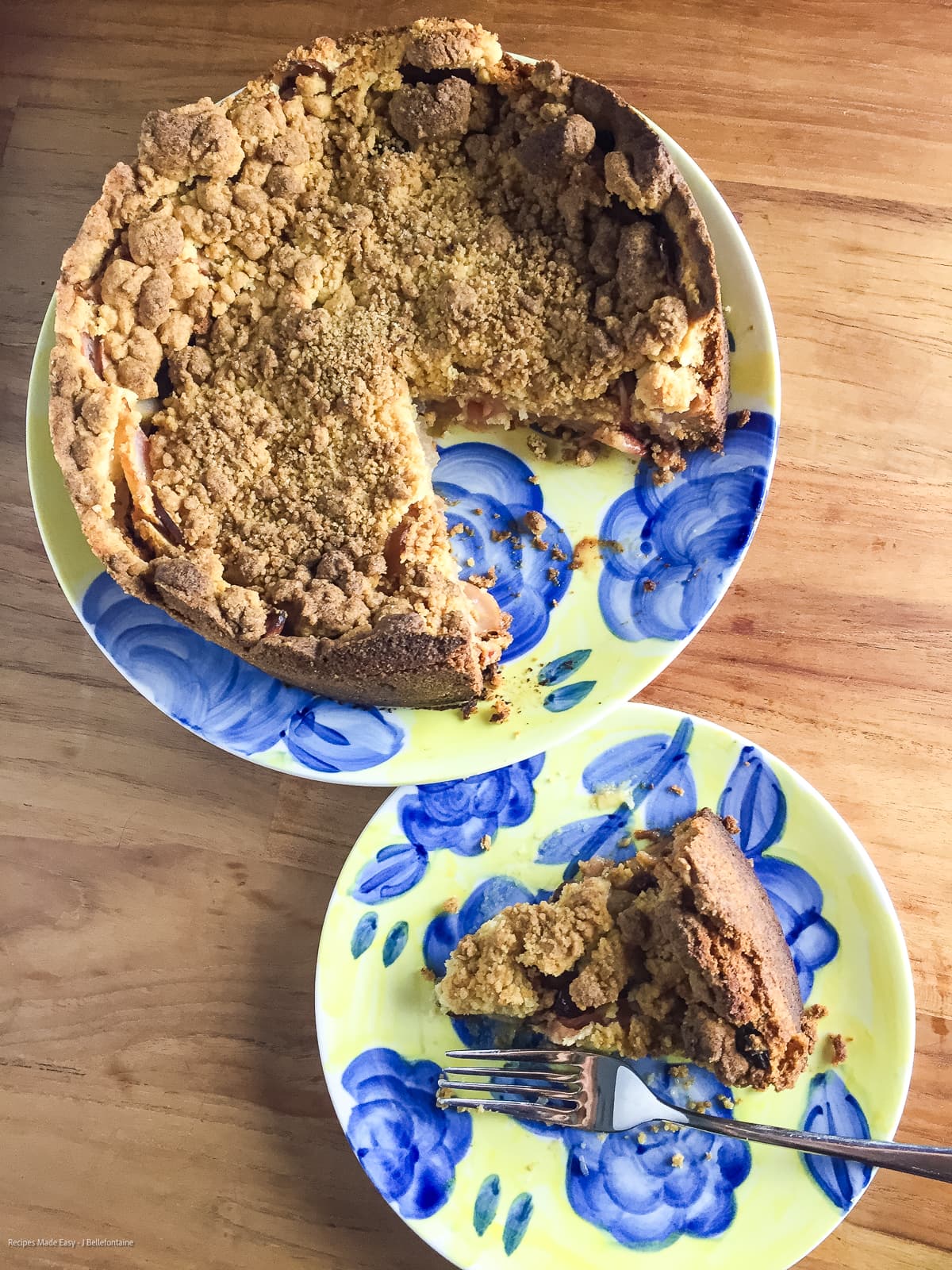 Dutch apple pie on yellow and blue plate with a slice removed and on a teaplate.