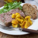 piccalilli on a slice of ham hock terrine served with bread and salad