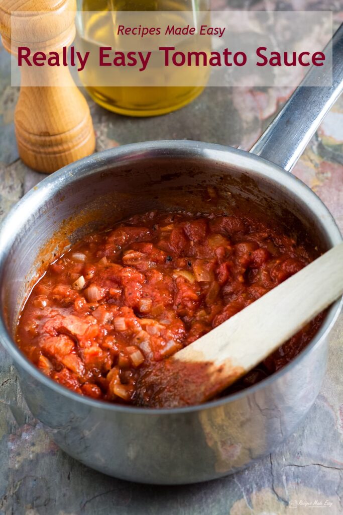 saucepan of really easy tomato sauce with wooden spatula for stirring.