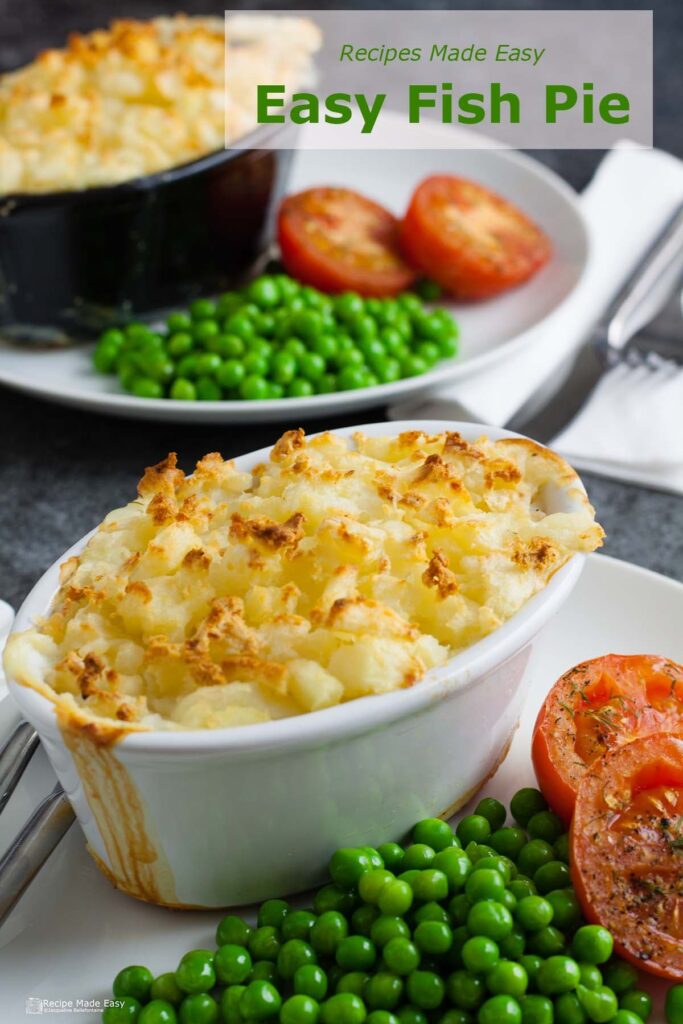 plate with easy fish pie served with peas and tomatoes.