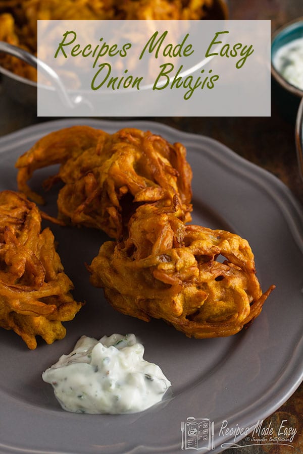 3 onion bhajis with cucumber raita on a serving plate