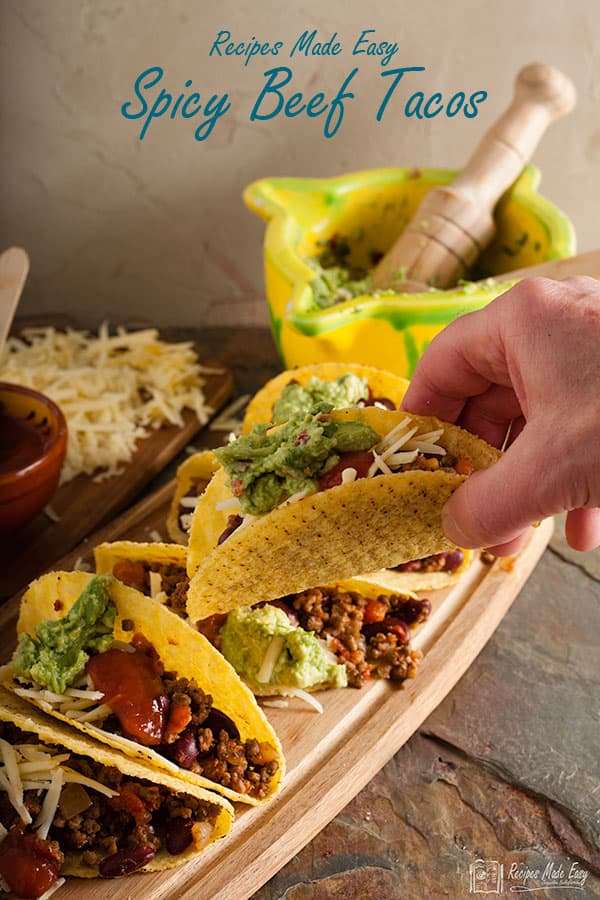 hand taking a spicy beef taco.