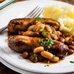 plate of sausages with easy homemade baked beans, served with mash.