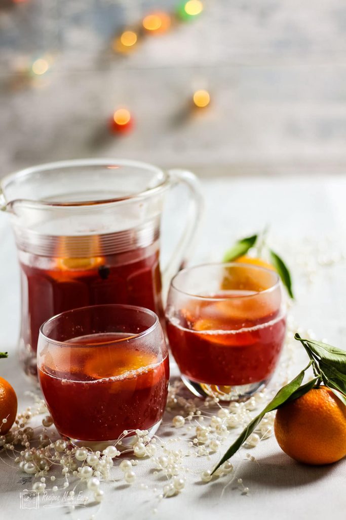 jug and glasses filled wih cranberry and clementine punch