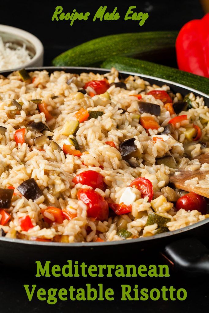Mediterranean Vegetable risotto in a pan with bowl of cheese, courgette and peppers behind.