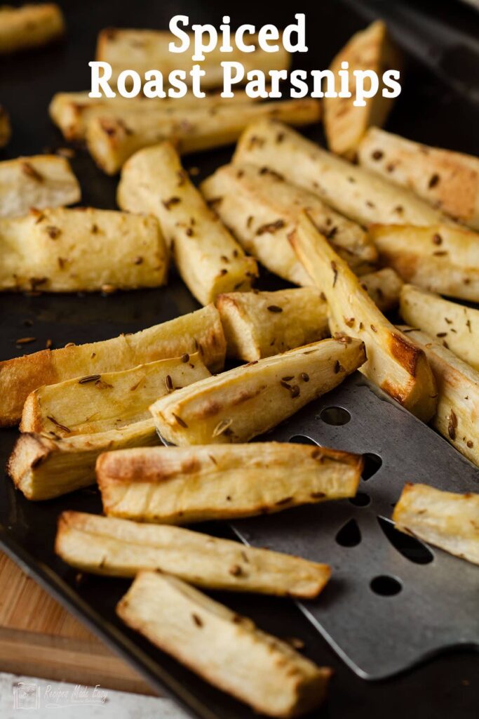 spiced roast parsnips on a baking tray.