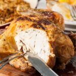 roast chicken part carved with carving knife and fork.