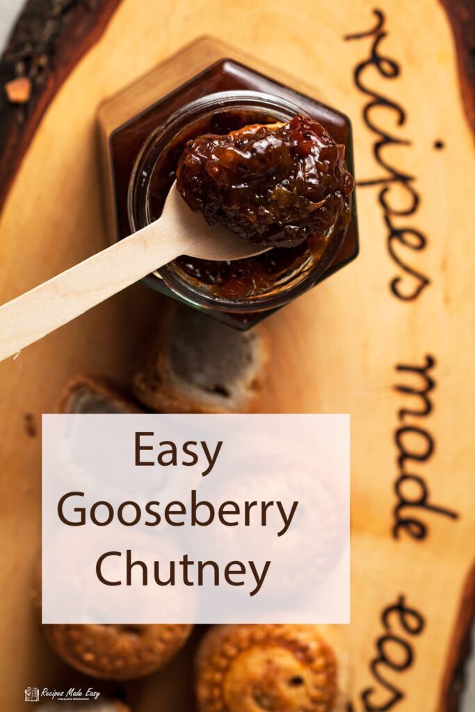 Spoon of gooseberry chutney resting on jar.